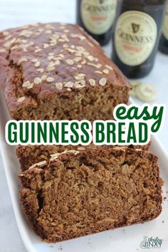 two slices of bread sitting on top of a white plate next to bottles of beer