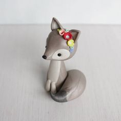 a small toy fox sitting on top of a table