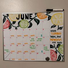 a calendar with fruit on it and the words june written in white paper next to oranges, lemons, and limes