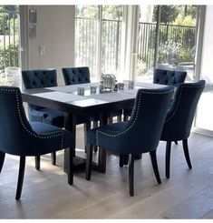 a dining room table with blue chairs around it