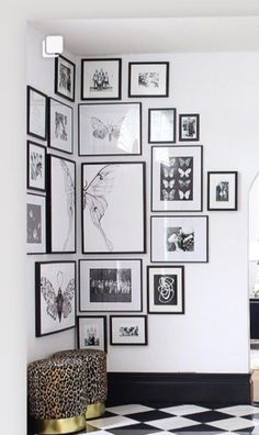 a white room with black and white pictures on the wall