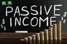 passive income written on a blackboard with stacks of coins