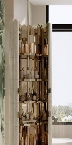 a bathroom with a shelf filled with bottles and candles