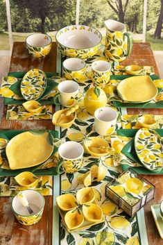 the table is set with yellow dishes and plates