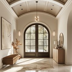 an elegant entry way with arched windows and doors