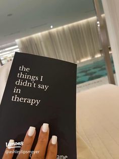 a woman's hand holding up a book that says the things i didn't say in therapy