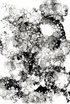 an abstract black and white painting with lots of bubbles on the bottom half of it