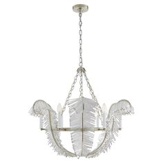 a white chandelier with feathers hanging from it