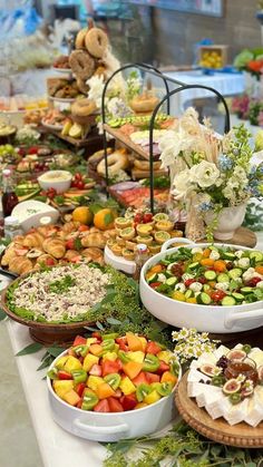 a buffet table filled with lots of different types of foods and desserts on it