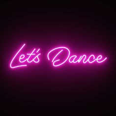 the words let's dance are lit up in pink and purple neon lights on a black background