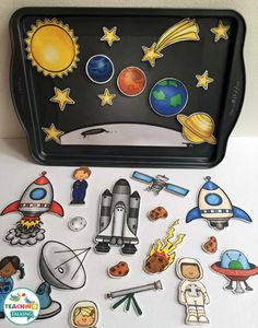 a tray with stickers and magnets on it, including an outer space theme