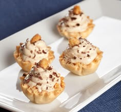 three small desserts on a white plate