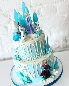 a frozen princess cake with frosting and decorations