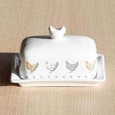 three chickens sitting on top of a white tray with hearts and hearts painted on it