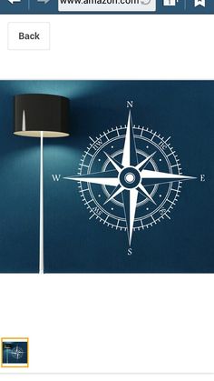 an image of a compass wall decal on the side of a room with a lamp next to it