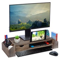 a computer monitor sitting on top of a wooden desk next to a keyboard and mouse