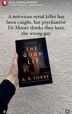 a person holding up a book in front of a white carpeted floor with the caption above it