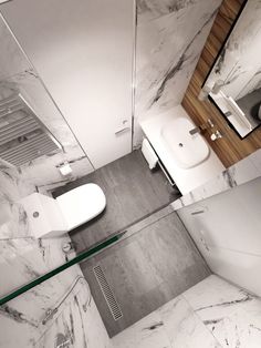 a bathroom with marble walls and flooring is shown in black and white color scheme