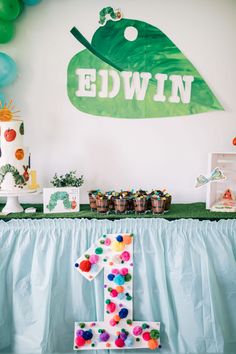 a table topped with lots of cake and balloons