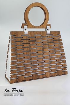 a wooden purse with metal handles on the front and sides, made out of wood