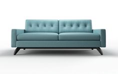 a blue couch sitting on top of a white floor