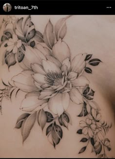 a woman's chest with flowers on it and leaves around the top half of her stomach