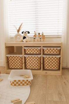 a room with some baskets and toys on the floor in front of a wooden shelf