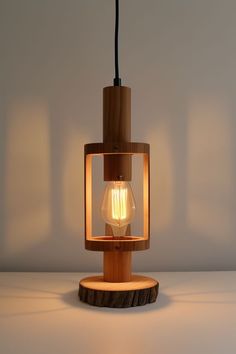 a light that is on top of a wooden stand with a light bulb in it