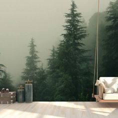 a living room with a couch and some trees in the background