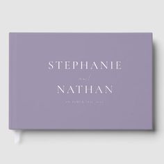 the cover of stephanie and nathan's wedding album, with white lettering on purple paper