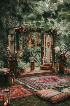 an outdoor area with rugs, lights and decorations on the ground in front of trees