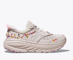 A new riff on our maximally cushioned road shoe, the Vibrant Bloom Bondi L is adapted for spring adventures with fresh pops of floral embroidery. Engineered with an early stage MetaRocker for a smooth transition through the gait cycle, this street staple features a premium nubuck upper, perforated panels, ultralight EVA midsole and marbled outsole. | Features. Floral embroidery. Marbled outsole. Nubuck leather upper. Early-stage MetaRocker geometry. Features a full-length EVA midsole. Beveled he Hoka Bondi Outfit, Cute Hoka Shoes, Hoka Outfit, Cool Running Shoes, Marathon Gear, Nimbus Cloud, 2024 Wishlist, Hoka Shoes, Colorful Sneakers