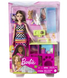 the barbie doll plays with her kitchen and furniture in its box, which is also on display