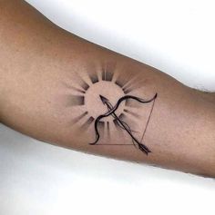 a tattoo on the arm of a person with an arrow and sun in the background