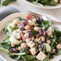 two plates filled with salad on top of a table