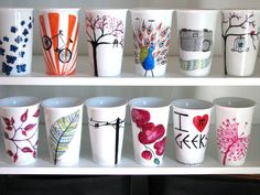 there are many different cups on the shelves