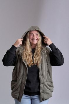 Stay warm and on-trend with our new and improved Hooded Puffer Vest! With its plush, insulated design and cozy removable hood, this vest is ideal for outdoor adventures. Layer it over any top for extra warmth without sacrificing style. Available in classic Army Green or Black, it's the go-to layering piece for chilly weather outings. Material + Wash Shell: 100% Cotton Lining: 100% Cotton Machine Wash Cold with Like Colors on Delicate Cycle Non-Chlorine Bleach when Needed Tumble Dry Low Heat Warm Cozy Puffer Jacket For Winter Outdoor, Cozy Winter Puffer Jacket For Outdoor, Winter Outdoor Vest With Fleece Lining, Khaki Vest For Outdoor Winter Activities, Khaki Puffer Jacket With Detachable Hood For Cold Weather, Casual Hiking Vest With Fleece Lining, Cozy Hooded Jacket For Cold Weather With Adjustable Hood, Functional Hooded Outdoor Vest, Sporty Hooded Vest For Outdoor Activities