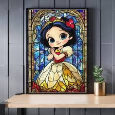 a disney princess stained glass window with a potted plant on the table next to it