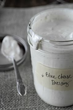 a jar of blue cheese dressing next to a spoon