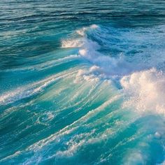 the water is blue and green with white waves