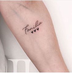 a woman's arm with the word family written in cursive writing