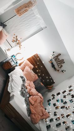 a bedroom with pink and white decor on the walls