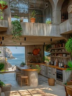 an open kitchen and dining area with plants on the counter, potted plants hanging from the balcony