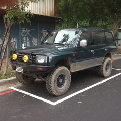 an suv parked in a parking space next to a building