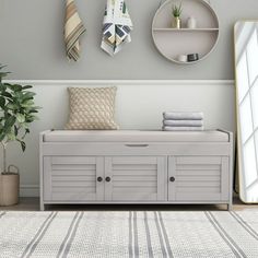 a white bench sitting in front of a mirror