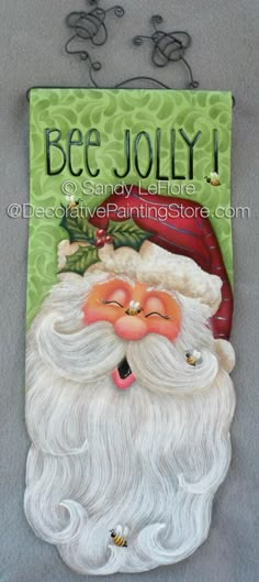 a painting of santa claus on the side of a sign that says bee jollyy