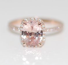 an engagement ring with a pink diamond in the center