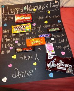 a valentine's day candy bar sign on a bed