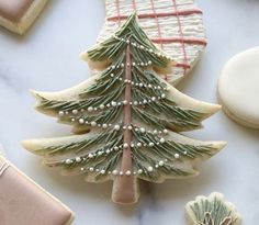 cookies decorated with icing and christmas tree decorations