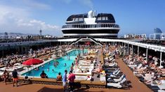 people are relaxing on the deck of a cruise ship while others swim in the pool